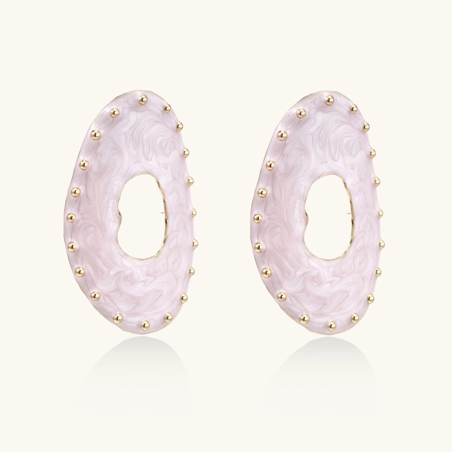 Oval lavender enamel earrings with gold studs around perimeter and cutout centers on white background