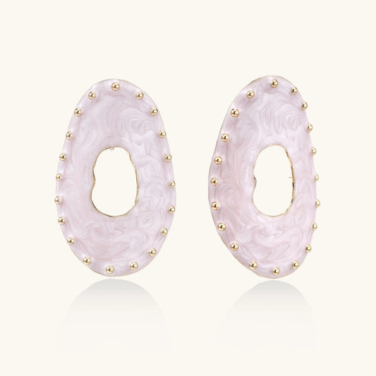 Oval lavender enamel earrings with gold studs around perimeter and cutout centers on white background