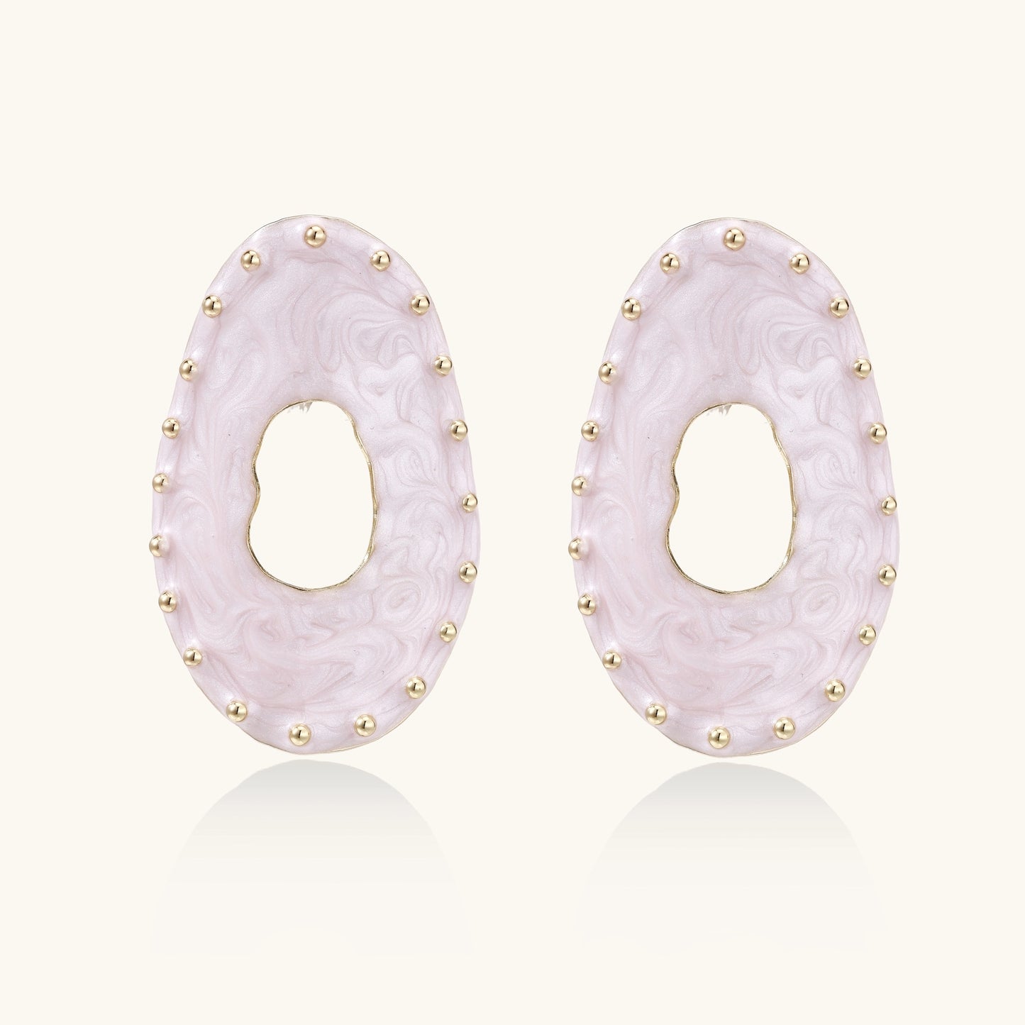 Oval lavender enamel earrings with gold studs around perimeter and cutout centers on white background