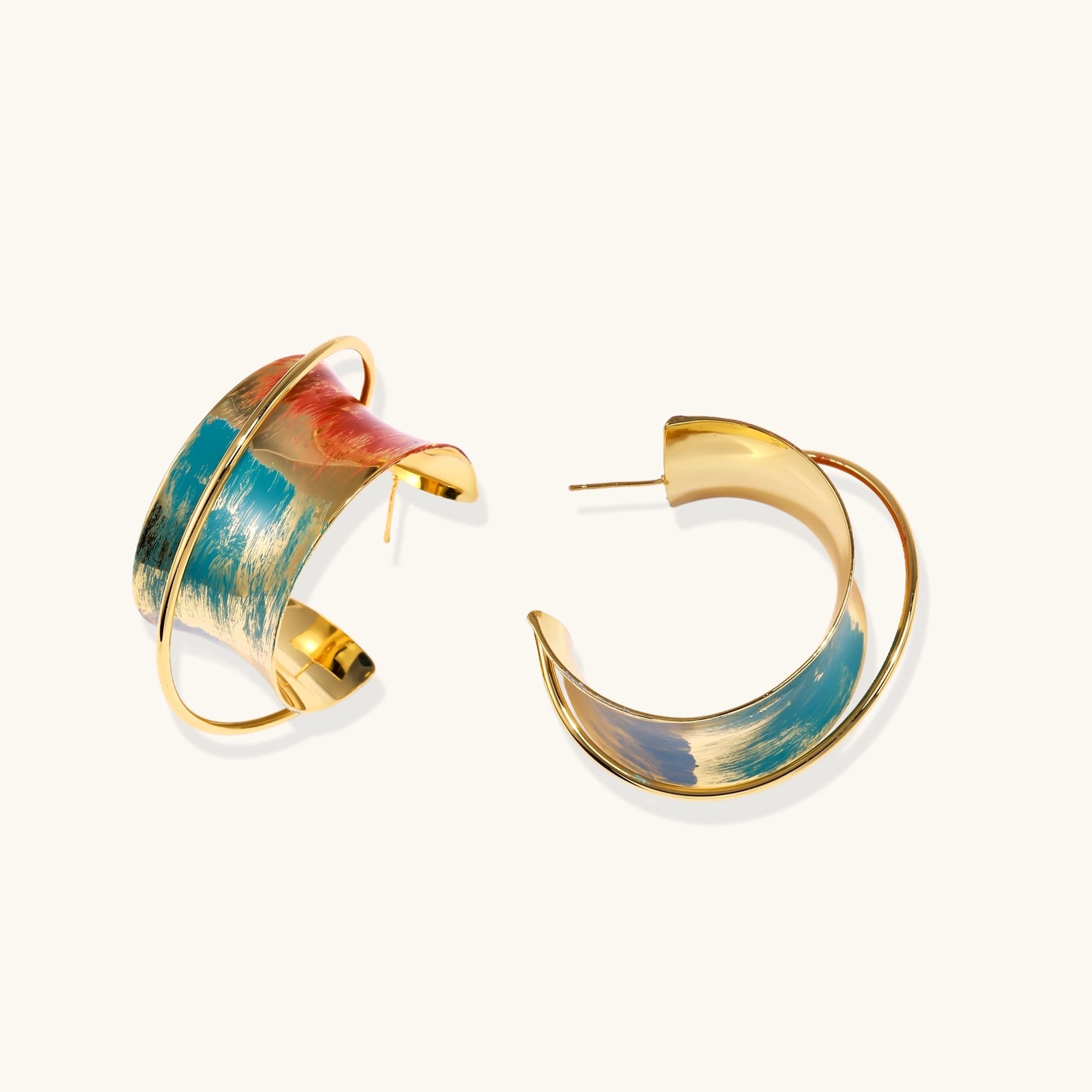 Gold-plated hoop earrings with colorful enamel brushstroke patterns in turquoise, coral, and gold tones
