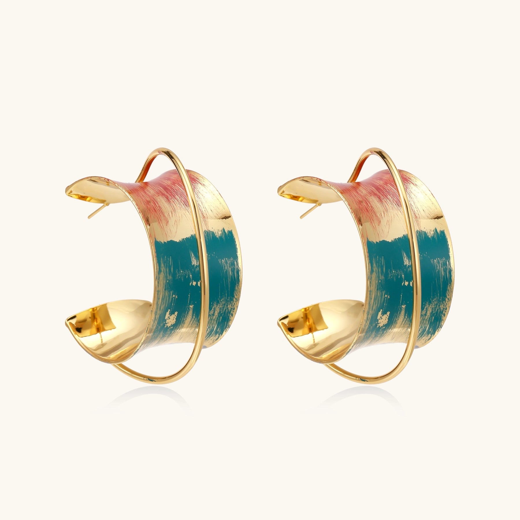 Gold-plated hoop earrings with colorful enamel brushstroke patterns in turquoise, coral, and gold tones